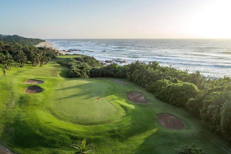 Golf course with ocean in the background